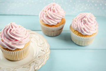 Pink cupcakes on wooden background