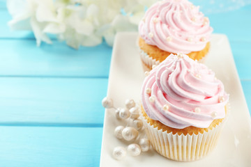 Pink cupcakes on wooden background