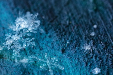 Snowflakes floating in a dusty space.