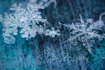 Snowflakes floating in a dusty space.