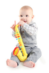 Adorable baby with plastic colourful saxophone isolated on white background