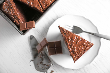 Delicious chocolate cake with nut cream on white table, close up