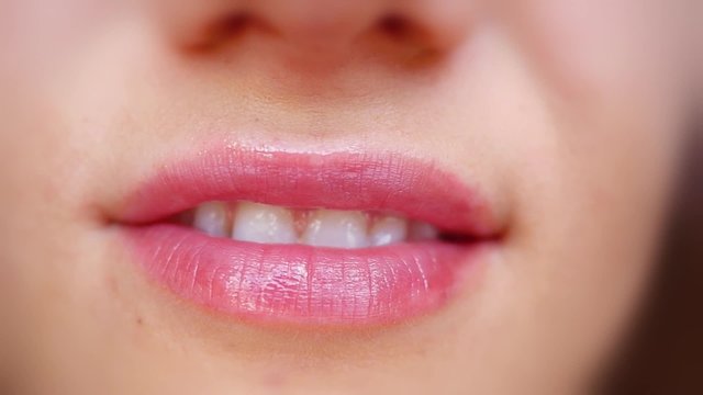 Extreme close up of lips and smiling with white teeth in slowmotion