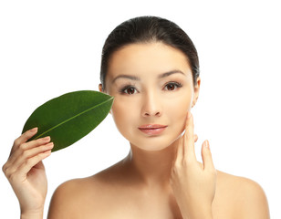 Portrait of beautiful woman with green leaf which isolated on white background
