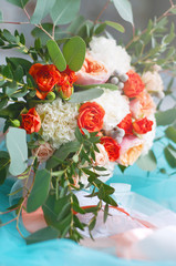 Beautiful bridal bouquet made of white and orange flowers