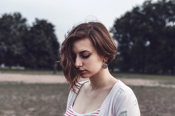 Gentle portrait of a sad girl outdoors