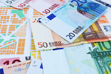 Different euro banknotes on a map background