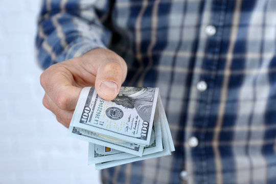 Man holding dollars in hand