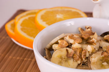 breakfast oatmeal with walnuts and slices of oranges