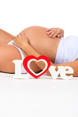 Close-up belly of pregnant woman. Concept of pregnancy and mother love.