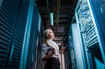 Young engineer businesswoman in network server room