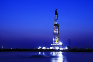 oilfield derrick at night