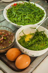 ingredient egg in green acacia pennata in white bowl