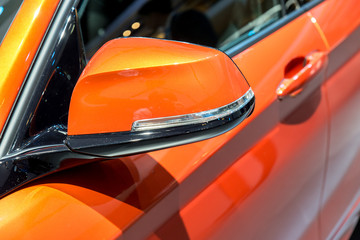 Close up of Orange Side Mirror Car