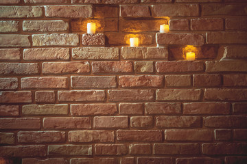 candles in brick wall