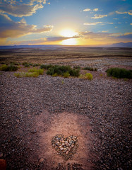Sunset over the Arizona desert with a heart made of pebbles