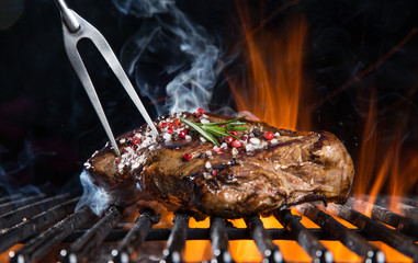 Beef steak on the grill. - obrazy, fototapety, plakaty