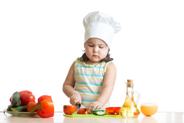 Child girl preparing healthy food in the kitchen