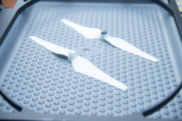 Small model propellers lying on print screen machine black plastic surface with bubble pattern
