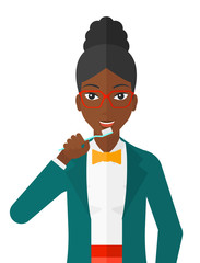 Woman brushing teeth.