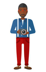 Smiling photographer holding camera.