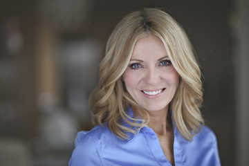 Portrait Of A Mature Businesswoman Smiling At The Camera
