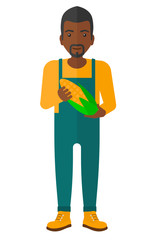 Farmer holding corn.