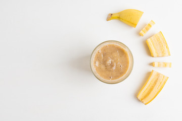 Banana smoothie on the wooden background