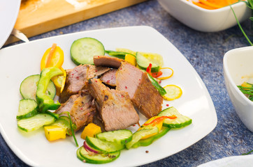 Delicious flank steak cuts cooked to perfection, mixed with reddish, zucchini and capsicum, elegant presentation