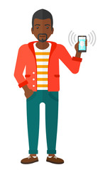 Man holding ringing telephone.