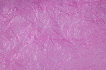Pink crumpled paper surface background.