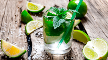 Freshly made mojito with mint and lime, sugar and rum. On a wooden table.