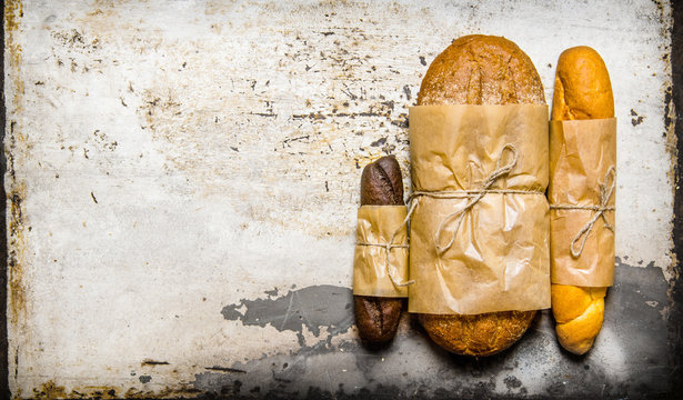 Set fresh bread on rustic background. Free space for text .