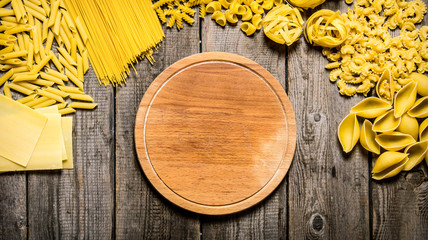 Mixed types of pasta and spaghetti with an empty plate.