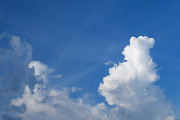 large cumulus cloud on clear blue sky background