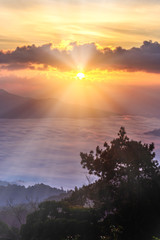 Fototapeta na wymiar Silhouette of Sunrise and mist with mountain at Huai Nam Dang National Park in Chiang Mai and Mae Hong Son, Thailand.