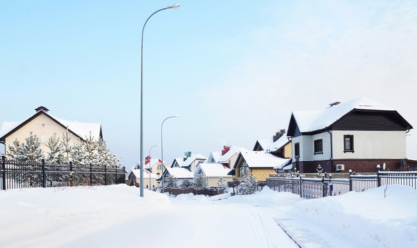 Snowy street with cottages in the winter village