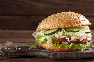 bitten veggie burger on a wooden background