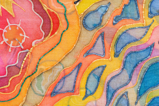 yellow, red, blue abstract ornament on silk batik