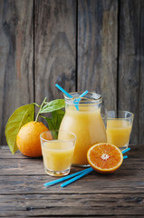 Healthy fresh orange juice on the woodent table