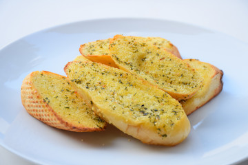 Garlic and herb bread slices. garlic bread against white background