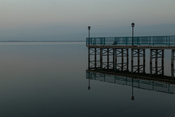 pier and its reflection on Lake Iznik, Turkey in the early evening
