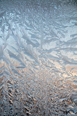 Ice floral pattern on glass macro view. Holiday seasonal background.
