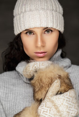 Portrait of brunette woman in winter sweater and hat.