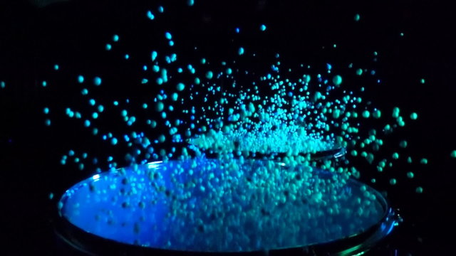 Close up of drums with small balls for special effect hit in slow motion over black background