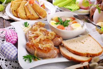 Fototapeta na wymiar white borscht and roasted sausage on easter table