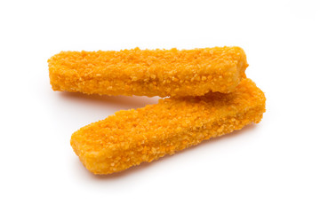 Frozen bread crumbed fish fingers on white.