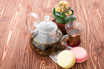 exotic green tea with flowers in glass teapot