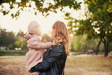 little girl in the arms of mother