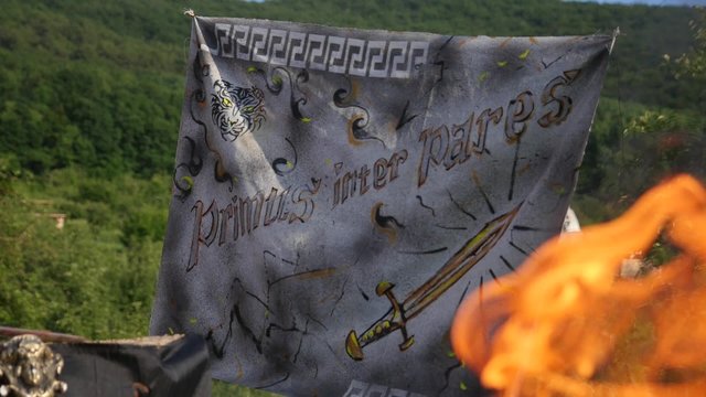 primus inter pares, a fire in a forest, the ancient Greek arena, an inscription in Latin, the Roman era